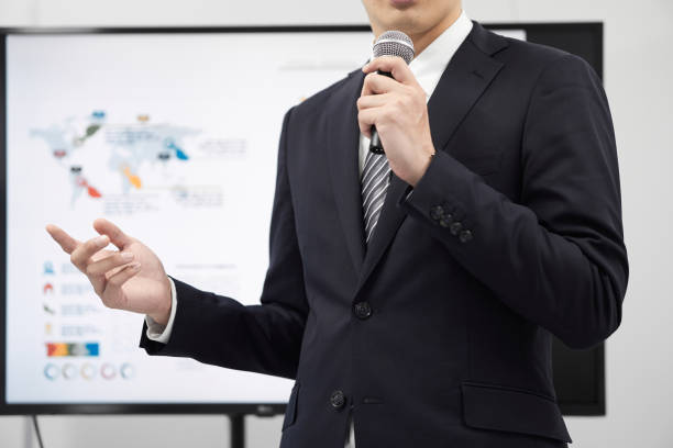 A Japanese male businessman giving a presentation.