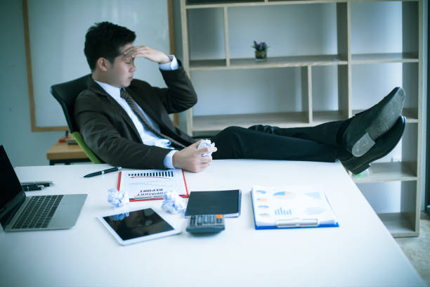 Serious Asia businessman was stressed in the office room : Overtime and serious concept