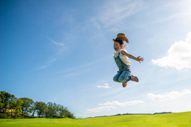 Girl jumping to the blue sky