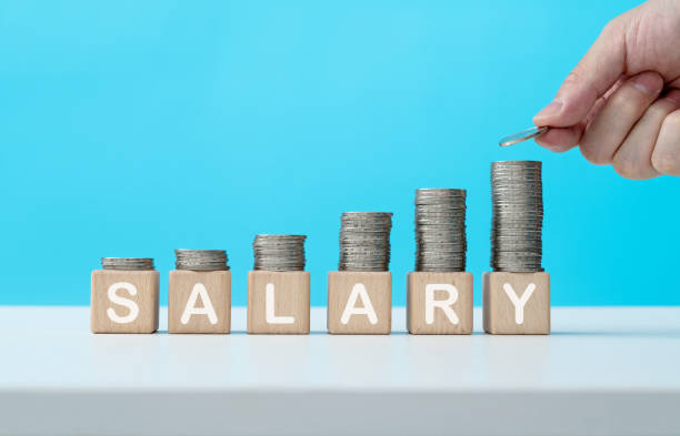  A young worker stands confidently in a modern office setting, with a cityscape view in the background. The scene includes upward-trending financial graphs and salary symbols like coins and arrows, with a prominent 300-400万円 figure. The image conveys success, ambition, and career planning.